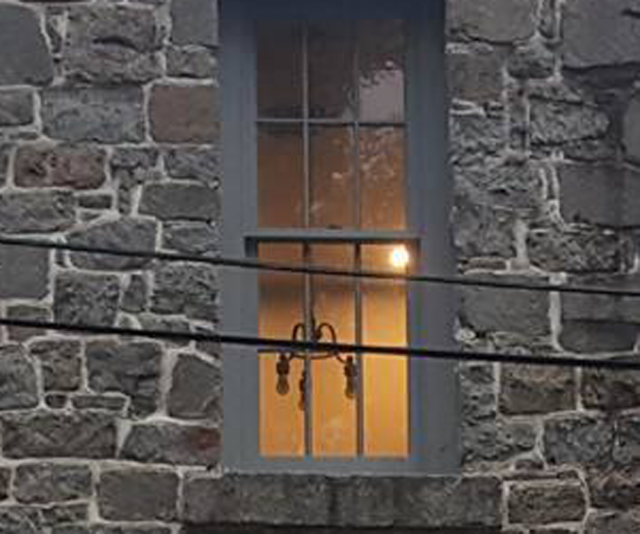 Face in the window of the old Princess Anne Jail - Photo by Desiree Wallace